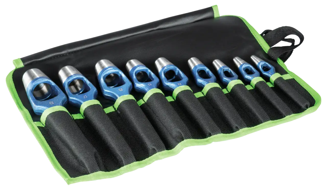 Set of nine blue and silver industrial punches in a black tool roll with green trim