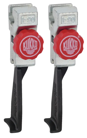 Pair of Kukko industrial puller tool clamps with red adjustment knobs and metal bodies