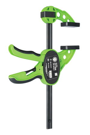 Green quick-release bar clamp tool with ergonomic grip for woodworking and shop use