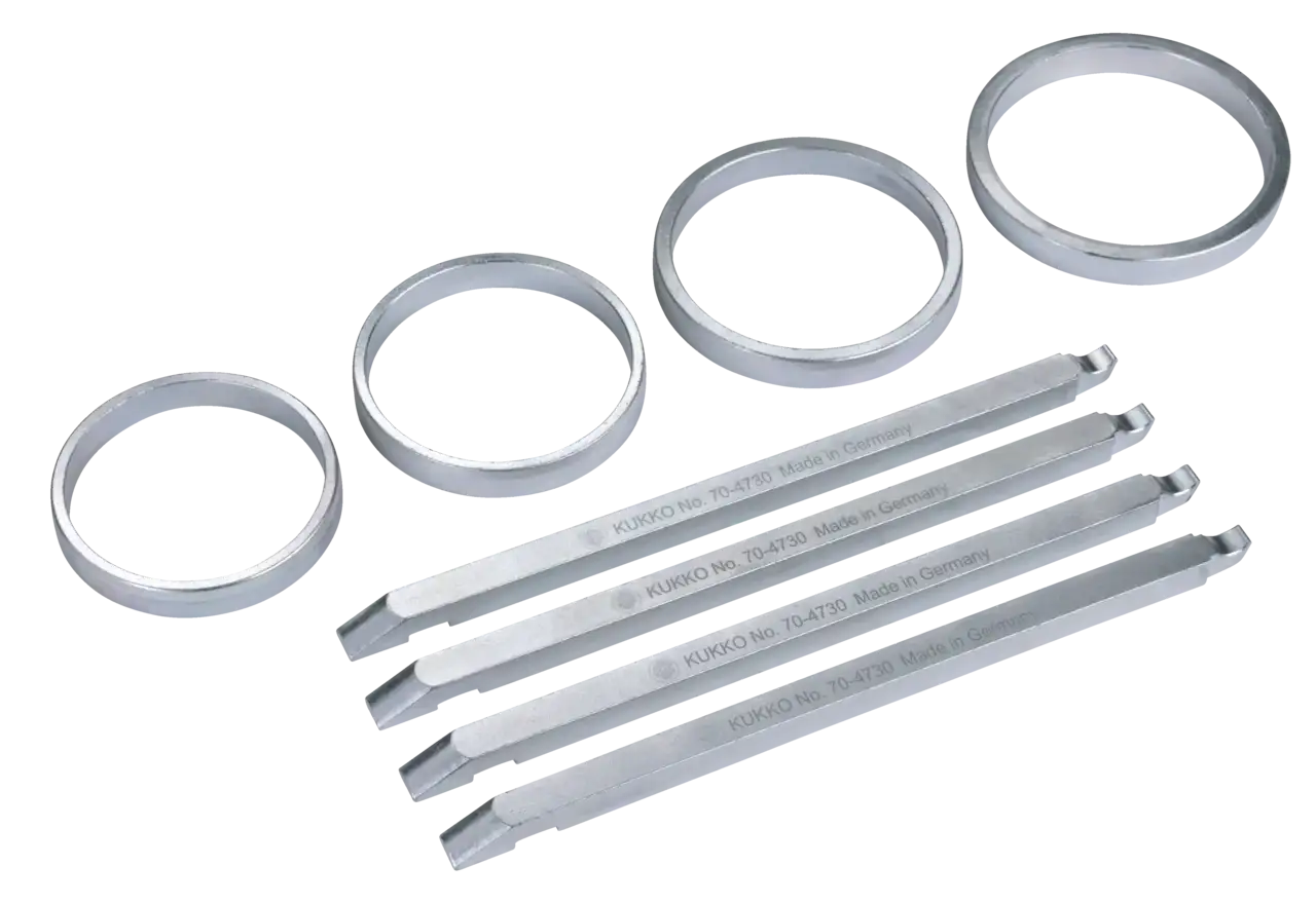 Industrial bearing separator rings and puller rods made of metal, used for shop tool repair.
