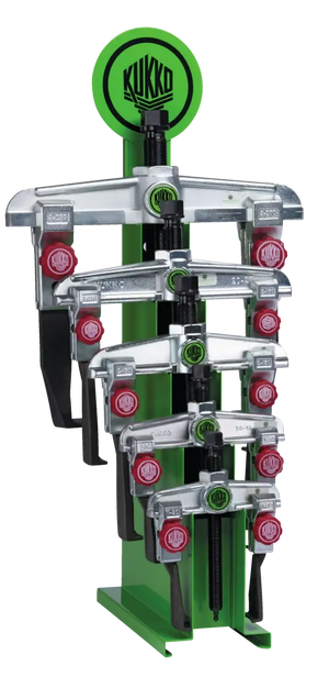 Metal puller tools displayed on a green stand, featuring Kukko branding, for industrial use