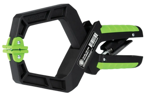 Heavy-duty black and green plastic spring clamp tool with textured grip for shop use