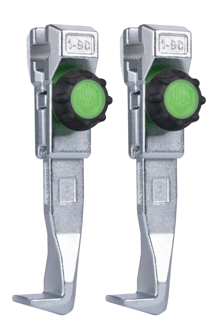 Pair of adjustable metal leveling feet with green knobs for industrial shop tools